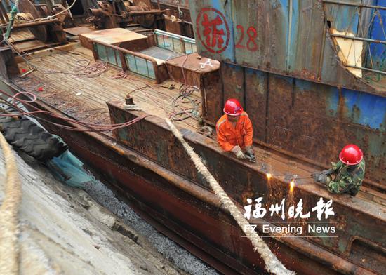 工人在拆解涉渔“三无”船舶。