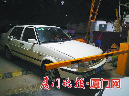 龙山山庄小区车库一处道闸的两侧都停了车。